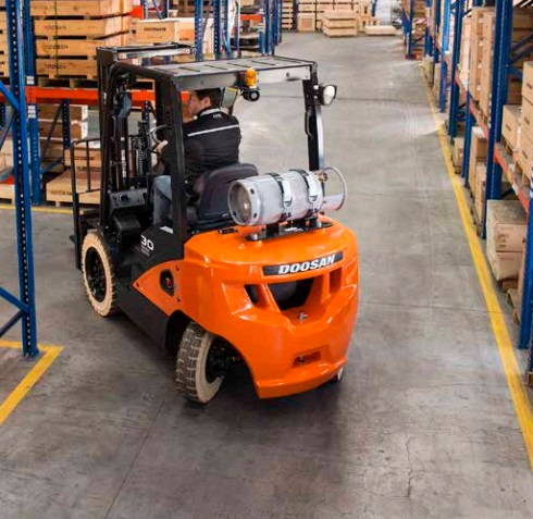 orange forklift carrying empty pallets